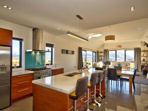 The open-plan kitchen, dining and lounge area of the award-winning Queenstown home. 